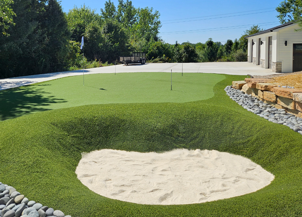 Synthetic grass putting green with real sand bunker in Ohio side yard