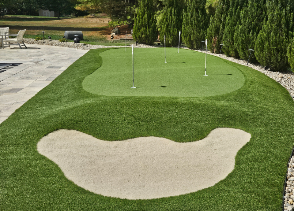 backyard putting green with artificial grass sand trap in Ohio